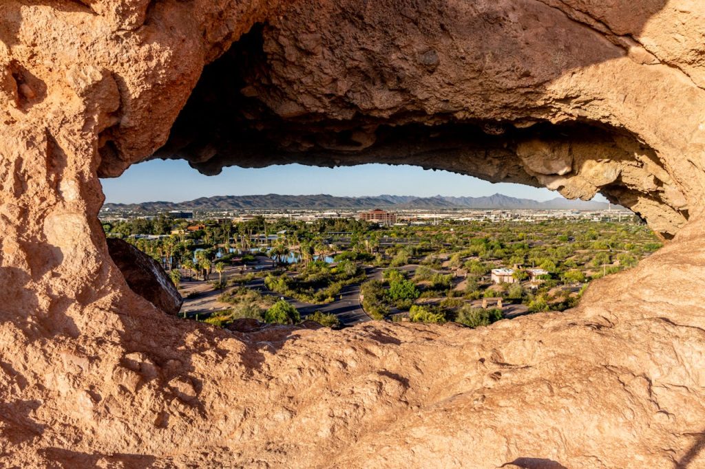 Capture of Phoenix cityscape through a unique rock formation in Papago Park, Arizona.